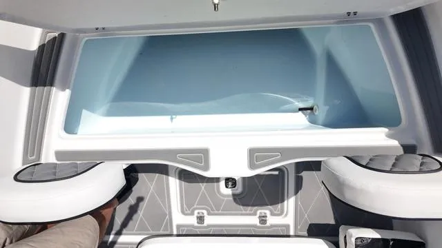 Slide: The Image of Interior view of 2025 Polar 195 CC boat, featuring seating and storage area. - 34