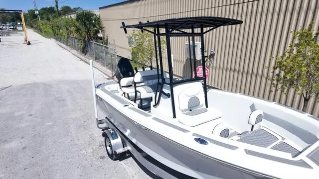 Slide: The Image of 2025 Polar 195 CC boat on trailer, parked outdoors near a building. - 36