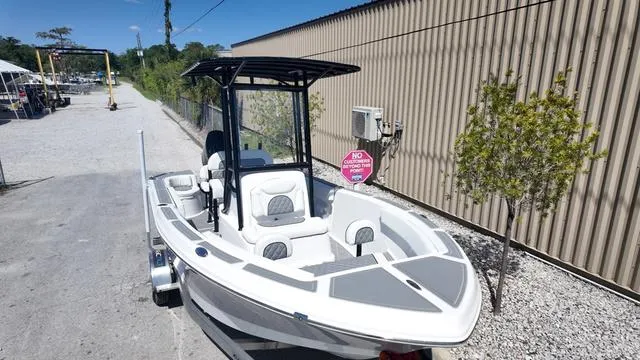 Slide: The Image of 2025 Polar 195 CC boat on trailer, parked outdoors near a building. - 37