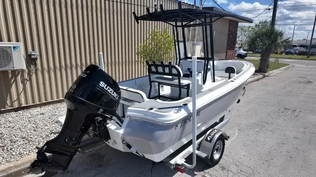 Slide: The Image of 2025 Polar 195 CC boat with Suzuki outboard motor on a trailer, parked outdoors. - 4