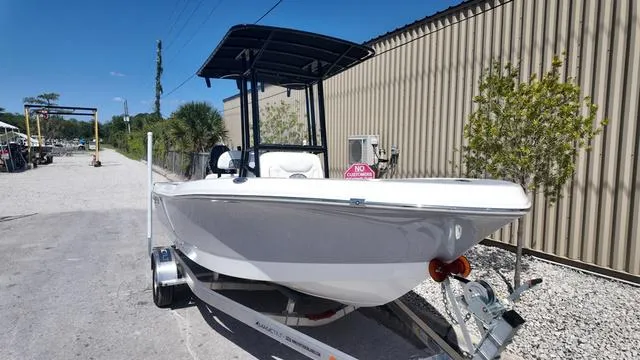 Slide: The Image of 2025 Polar 195 CC boat on trailer, parked outdoors near a building. - 7