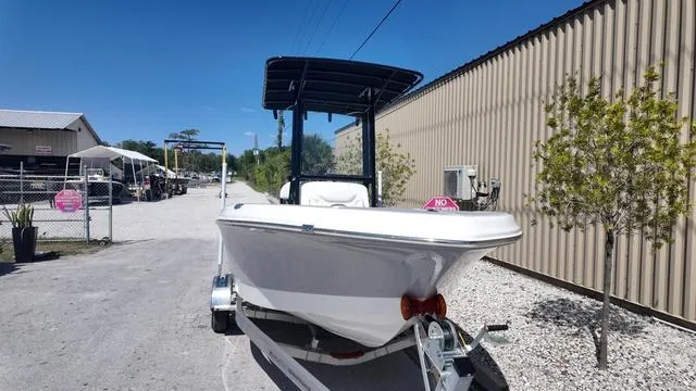 Slide: The Image of 2025 Polar 195 CC boat on trailer, parked outdoors near industrial building. - 8