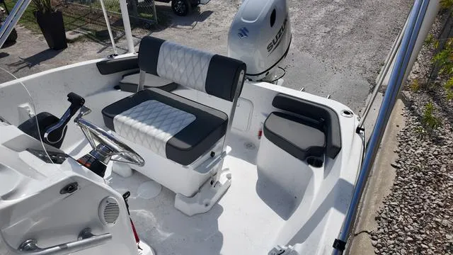 Slide: The Image of 2025 ALK2 18CRS boat interior with seating and steering wheel, featuring Suzuki outboard motor. - 13