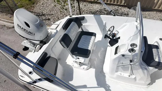 Slide: The Image of 2025 ALK2 18CRS boat interior with Suzuki outboard motor, featuring seating and steering console. - 14
