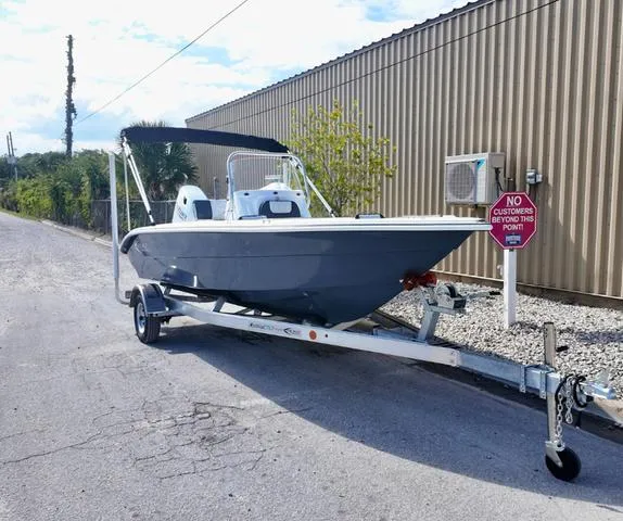 Slide: The Image of 2025 ALK2 18CRS boat on trailer near industrial building. - 16