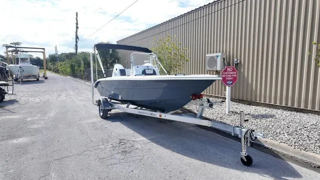 Slide: The Image of 2025 ALK2 18CRS boat on trailer near a metal building. - 22