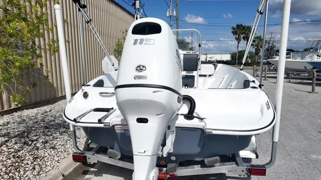 Slide: The Image of 2025 ALK2 18CRS boat with 115 horsepower engine, parked outdoors on a trailer. - 27