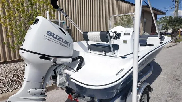 Slide: The Image of 2025 ALK2 18CRS boat with Suzuki outboard motor, parked outdoors. - 28