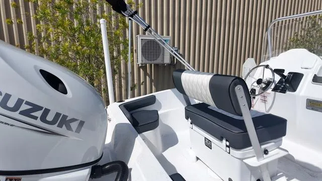 Slide: The Image of 2025 ALK2 18CRS boat with Suzuki engine, featuring a sleek white and black interior design. - 30