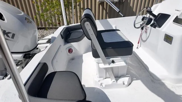Slide: The Image of Interior of 2025 ALK2 18CRS boat with seating and steering wheel. - 31