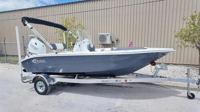 Slide: The Image of 2025 ALK2 18CRS boat on trailer, parked outdoors, with outboard motor and canopy. - 37