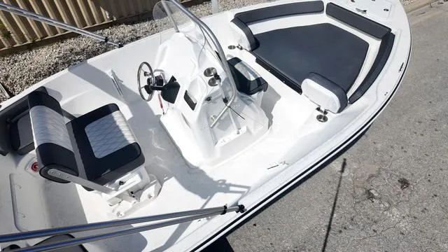 Slide: The Image of 2025 ALK2 18CRS boat interior with seating and steering console. - 4