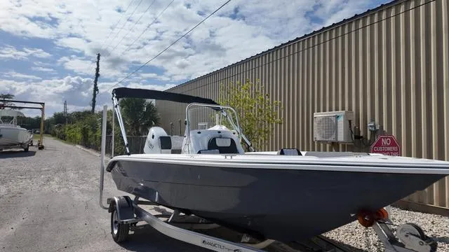 Slide: The Image of 2025 ALK2 18CRS boat on trailer near industrial building under cloudy sky. - 44