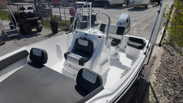 Slide: The Image of 2025 ALK2 18CRS boat with sleek design and comfortable seating in a marina setting. - 6