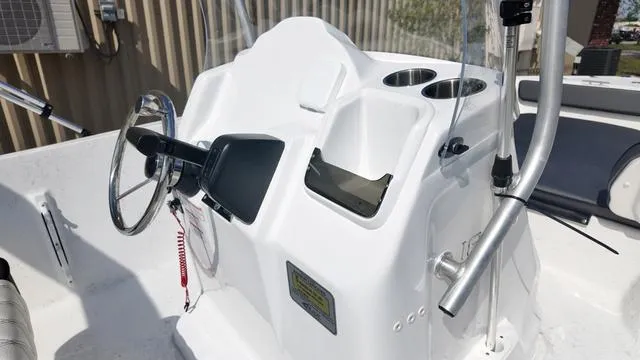 Slide: The Image of 2025 ALK2 18CRS boat console with steering wheel and cup holders. - 7