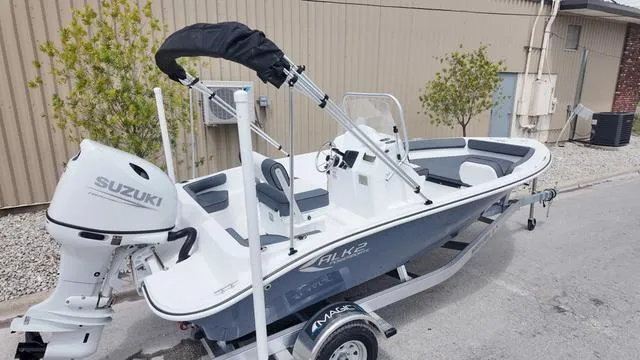 Slide: The Image of 2025 ALK2 18CRS boat with Suzuki engine on trailer, parked outdoors. - 9