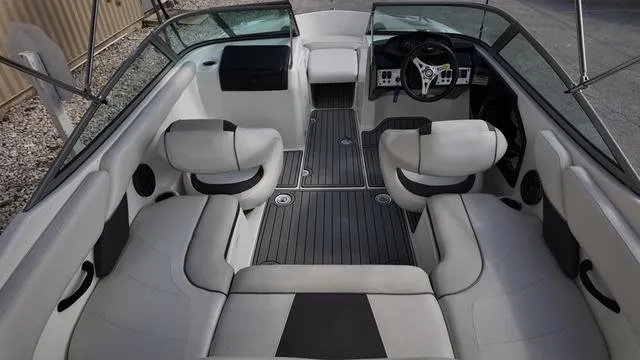 Slide: The Image of 2013 Yamaha Boats SX192 interior with sleek seating and modern dashboard design. - 10