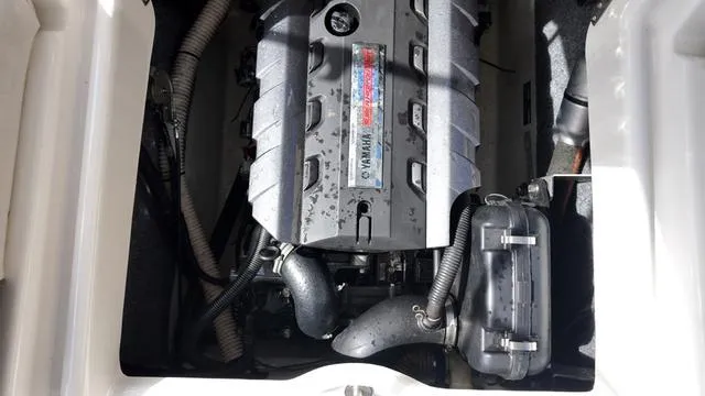 Slide: The Image of Engine compartment of a 2013 Yamaha Boats SX192, showcasing the engine and components. - 18
