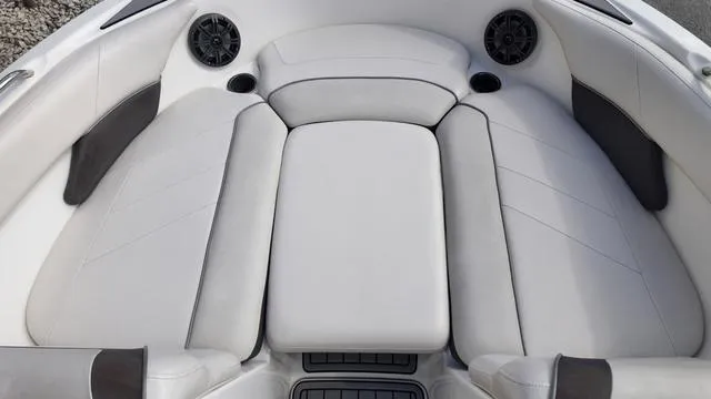 Slide: The Image of 2013 Yamaha Boats SX192 interior with white cushioned seating and built-in speakers. - 20