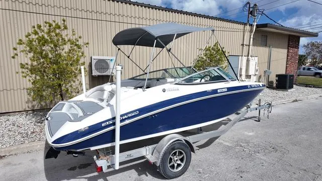 Slide: The Image of 2013 Yamaha Boats SX192 on trailer, blue and white, parked outdoors. - 3
