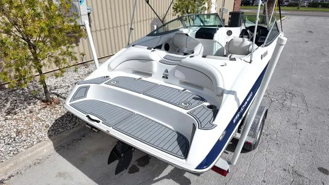 Slide: The Image of 2013 Yamaha Boats SX192 on trailer, rear view, showcasing spacious deck and seating. - 4