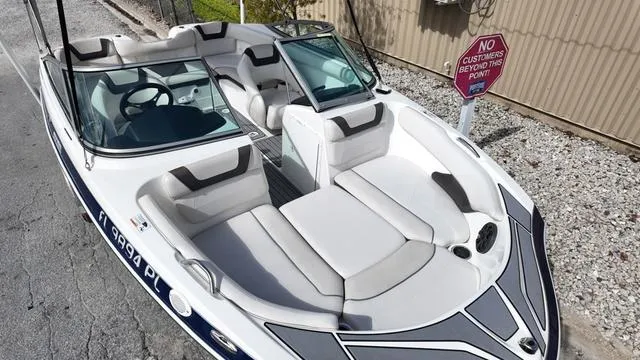 Slide: The Image of 2013 Yamaha Boats SX192 with sleek design and comfortable seating, parked near a "No Customers" sign. - 7