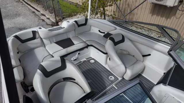 Slide: The Image of 2013 Yamaha Boats SX192 interior with white and black seating, spacious layout, and modern design. - 8