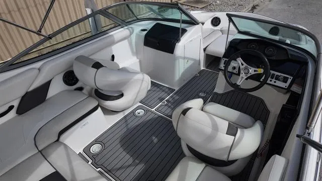 Slide: The Image of 2013 Yamaha Boats SX192 interior with sleek seating and modern dashboard design. - 9