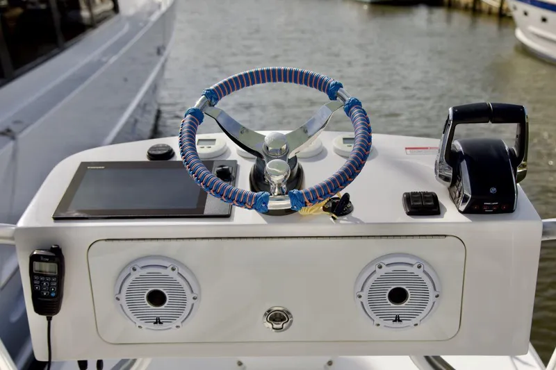 Slide: The Image of 2024 SeaVee 390Z boat helm with modern controls and blue-wrapped steering wheel. - 15