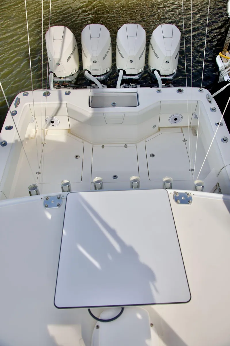 Slide: The Image of 2024 SeaVee 390Z boat with four powerful outboard engines, spacious deck layout. - 16