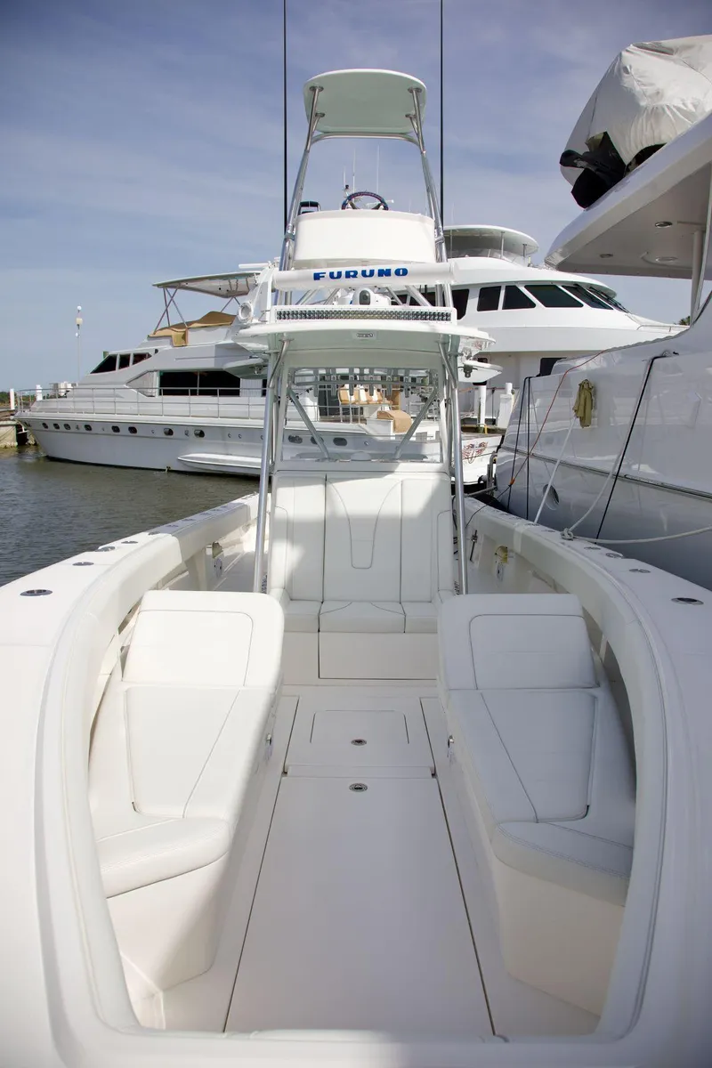Slide: The Image of 2024 SeaVee 390Z boat docked, showcasing sleek design and spacious deck. - 17