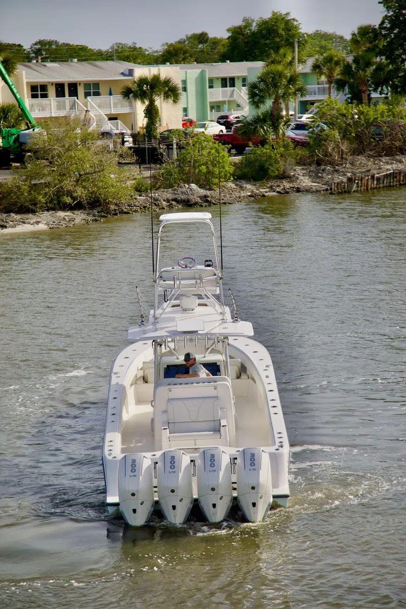 Slide: The Image of 2024 SeaVee 390Z boat with quad engines navigating a calm waterway. - 4