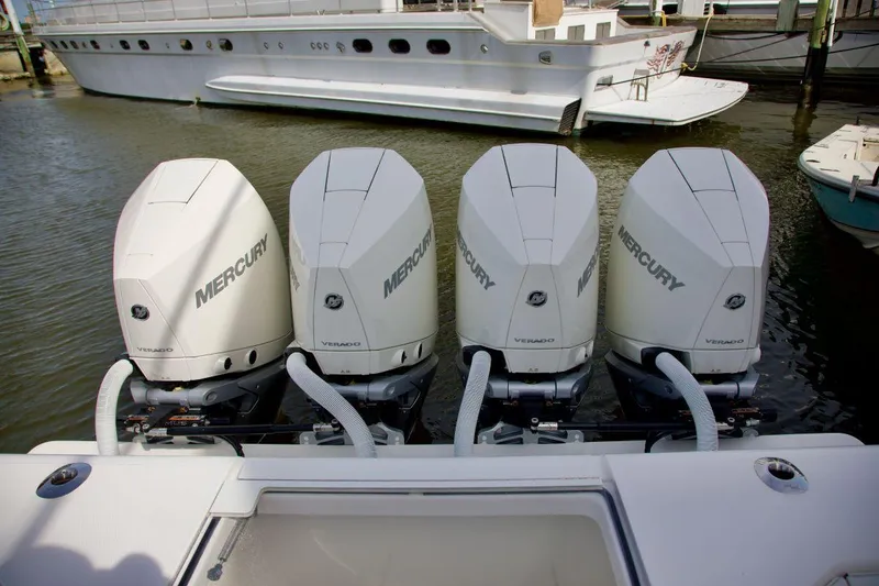 Slide: The Image of Four Mercury outboard engines on a 2024 SeaVee 390Z boat, docked in a marina. - 5
