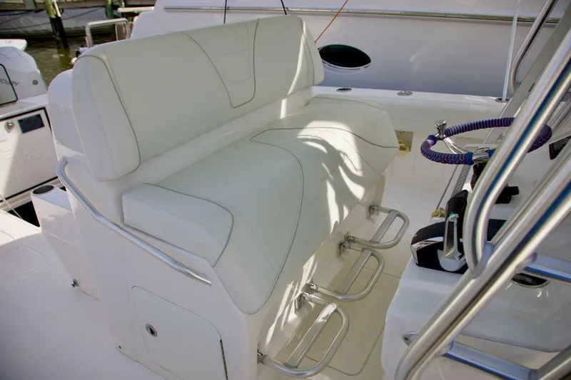 Slide: The Image of 2024 SeaVee 390Z boat seating area with white upholstery and stainless steel footrests. - 9