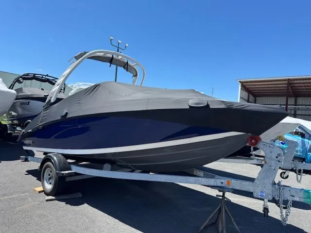 Slide: The Image of 2021 Yamaha Boats 195S on trailer, covered, in outdoor storage. - 2