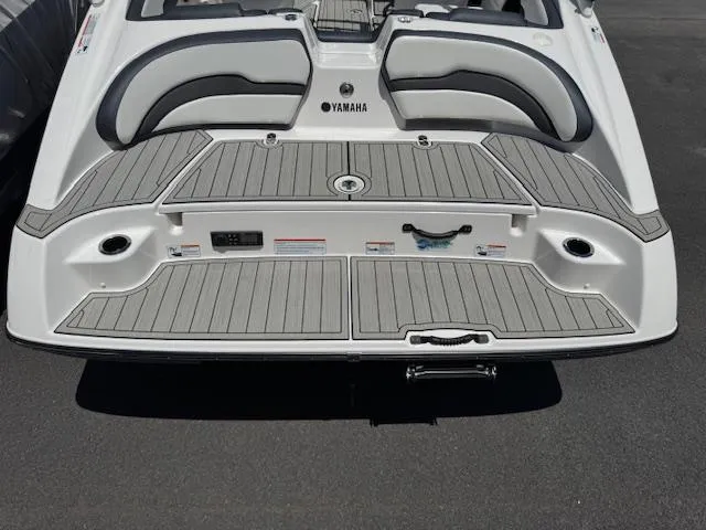 Slide: The Image of 2021 Yamaha Boats 195S swim platform with gray decking and seating. - 23