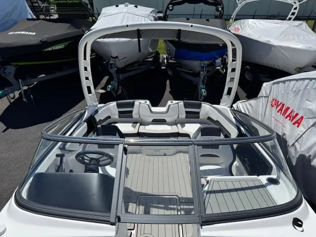 Slide: The Image of 2021 Yamaha Boats 195S with sleek interior and modern design, displayed among covered boats. - 6