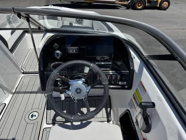 Slide: The Image of 2021 Yamaha Boats 195S cockpit with steering wheel and control panel. - 8