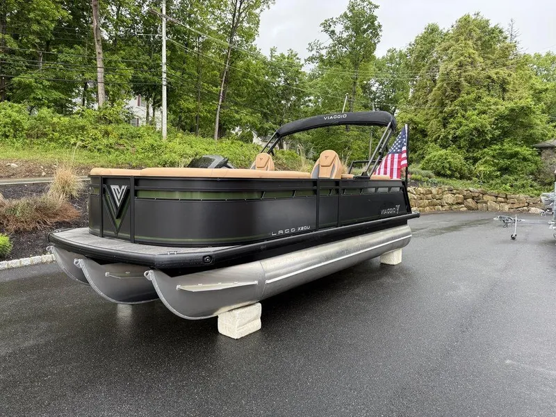Slide: The Image of 2025 Viaggio X20U Tri-Toon boat with 25" tubes, parked on a wet driveway. - 6
