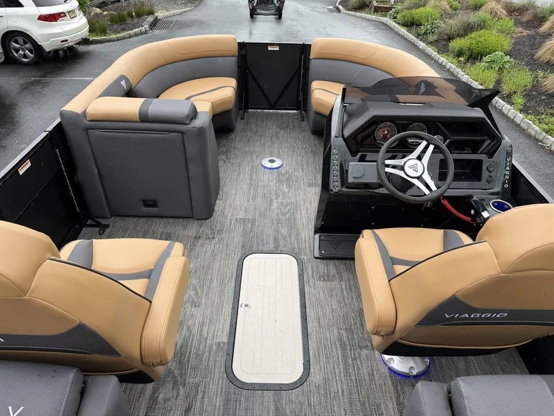 Slide: The Image of 2025 Viaggio X20U Tri-Toon boat interior with tan seating and modern helm. - 7