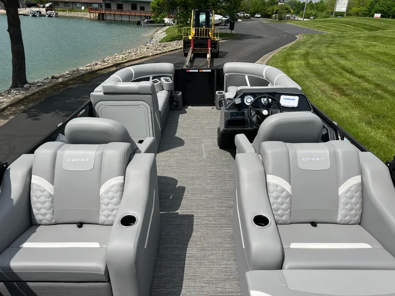 Slide: The Image of 2025 Crest Classic 220 SLRC pontoon boat with luxurious seating and modern design. - 10