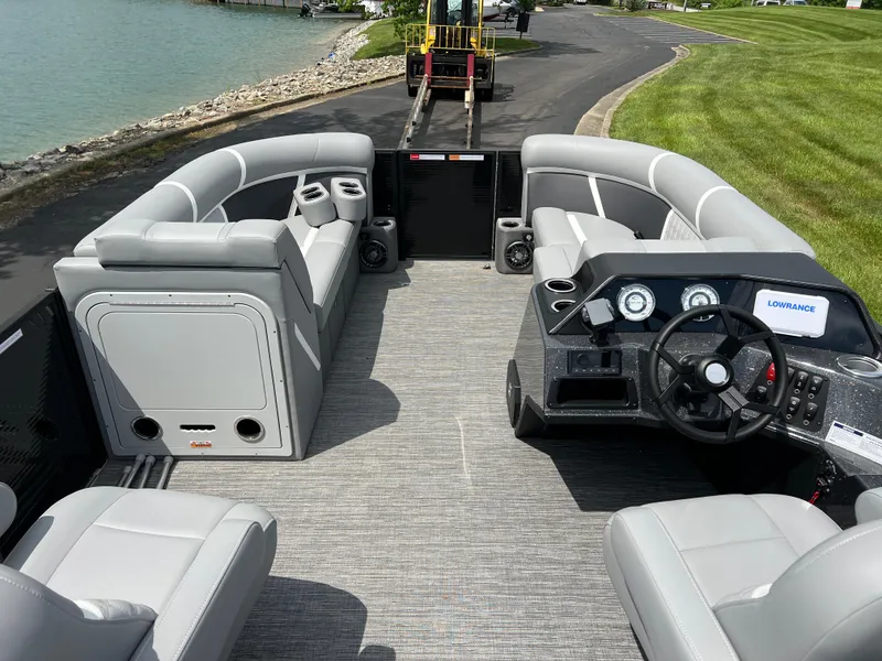 Slide: The Image of 2025 Crest Classic 220 SLRC pontoon boat interior with gray seating and modern dashboard. - 11
