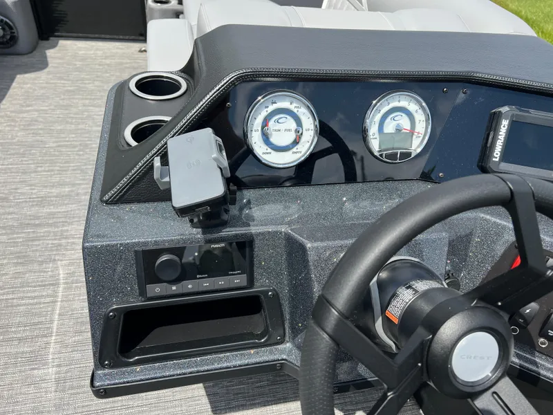 Slide: The Image of 2025 Crest Classic 220 SLRC dashboard with gauges, steering wheel, and cup holders. - 13