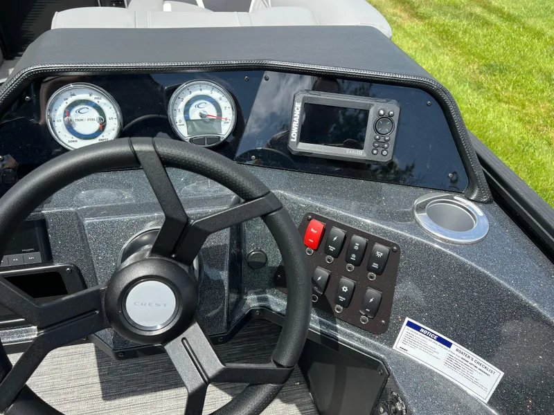 Slide: The Image of 2025 Crest Classic 220 SLRC dashboard with steering wheel, gauges, and control panel. - 14