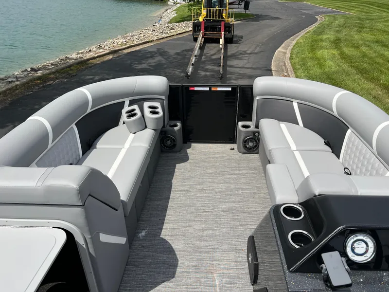 Slide: The Image of 2025 Crest Classic 220 SLRC pontoon boat interior with gray seating and cup holders. - 16