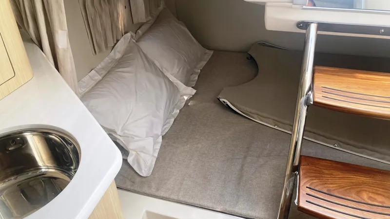 Slide: The Image of 2025 Regal 28 Express boat interior with kitchenette, sink, and seating area. - 10