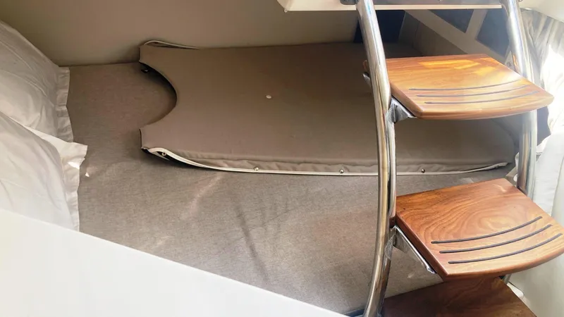 Slide: The Image of Interior of 2025 Regal 28 Express boat featuring kitchenette and seating area. - 11