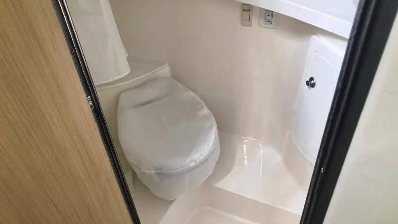 Slide: The Image of 2025 Regal 28 Express cabin interior with bed, sink, and wooden stairs. - 12