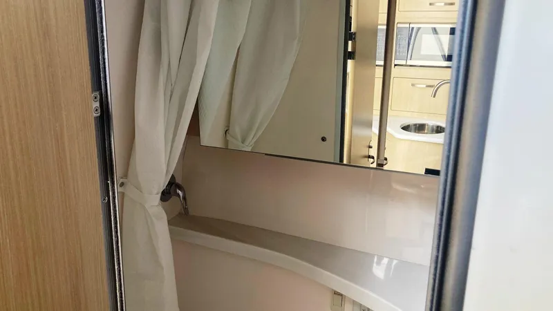 Slide: The Image of 2025 Regal 28 Express cabin interior with bed and wooden steps. - 13