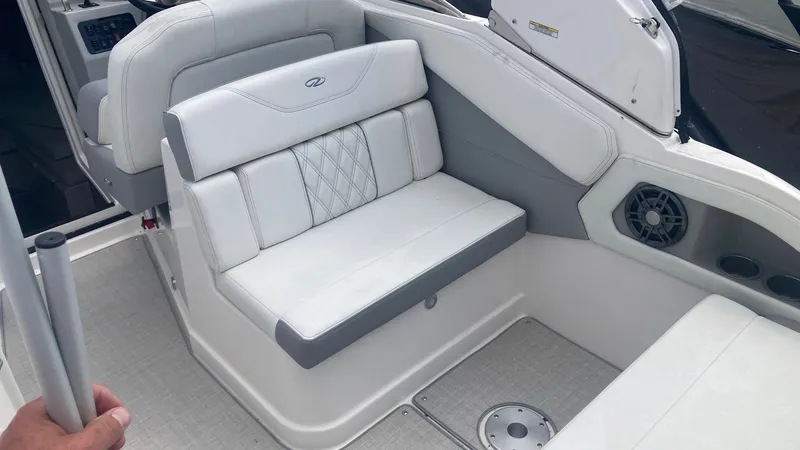 Slide: The Image of 2025 Regal 28 Express boat interior with white seating and cup holders. - 5